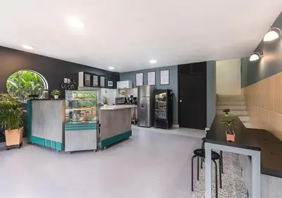 a restaurant with a counter and a refrigerator at Living Hotel in Medellín