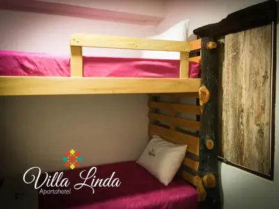 a bunk bedded room with a bunk bed in a room at Villa Linda ApartaHotel in Jericó