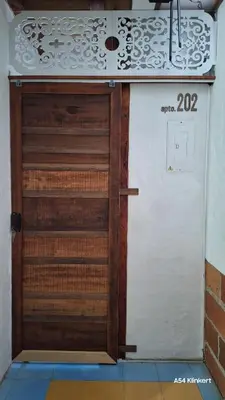 a wooden door in a room with a wall at Villa Linda ApartaHotel in Jericó