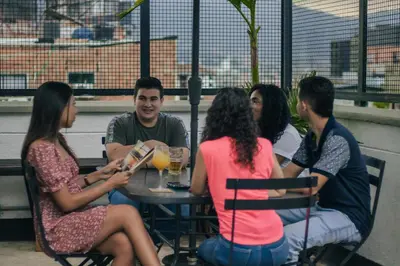 a group of people sitting around a table at Rango Hostel Boutique in Medellín