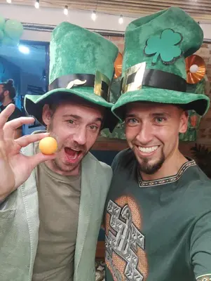 two men dressed in green hats posing for a picture at Rango Hostel Boutique in Medellín
