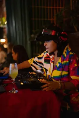 a woman wearing a hat and headphones playing a video game at Rango Hostel Boutique in Medellín