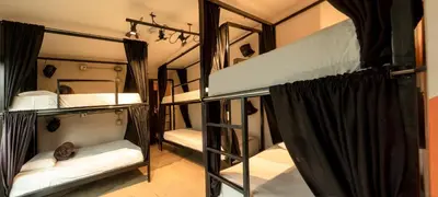a room with three bunk beds in a room at Rango Hostel Boutique in Medellín