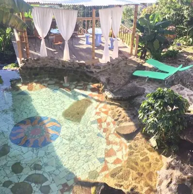 a patio with a pool with a table and an umbrella at Monte Mágico in Támesis