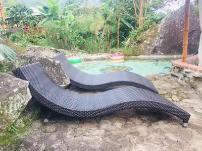 a bench sitting in front of a swimming pool at Monte Mágico in Támesis