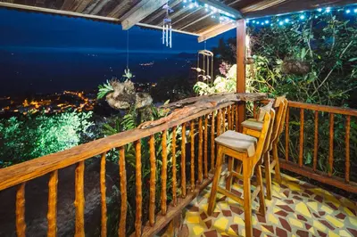 a porch with a chair and a view of the ocean at Monte Mágico in Támesis