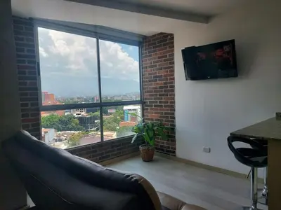a living room with a large window with a view at All Inclusive Suites in Medellín