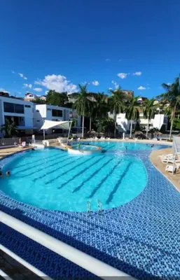 a large swimming pool with blue water at Ciudadela Santafe in Santa Fe de Antioquia