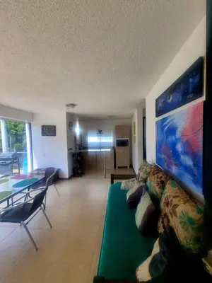 a living room with a couch and a table at Ciudadela Santafe in Santa Fe de Antioquia