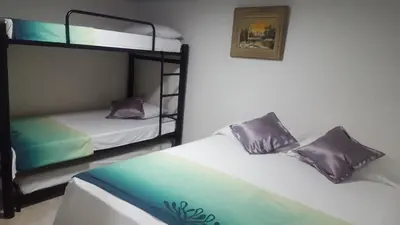 two bunk beds in a room with acknowled at Hotel La Castellana in Manizales