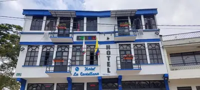a white and blue building with windows and balconies at Hotel La Castellana in Manizales