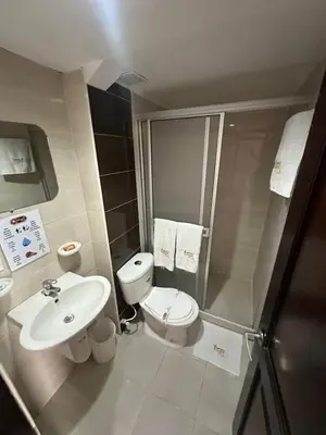 a bathroom with a sink and a toilet and a shower at Hotel Royal Suite in Manizales