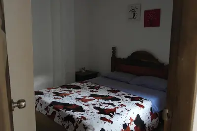 a bedroom with a bed with a quilt on it at Sergeant Pepper's Hostel in Jardin
