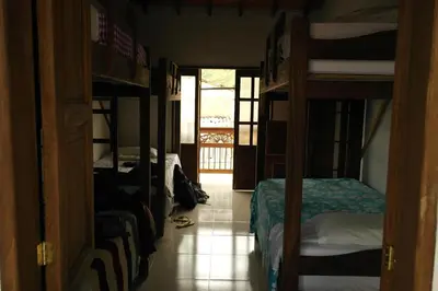 a room with two bunk beds and a hallway at Sergeant Pepper's Hostel in Jardin