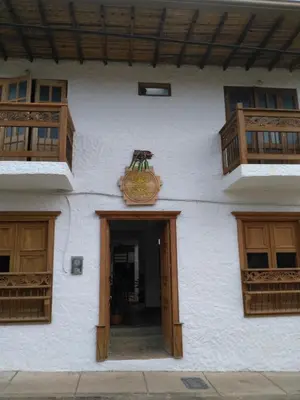 a building with a door and a sign on it at Sergeant Pepper's Hostel in Jardin