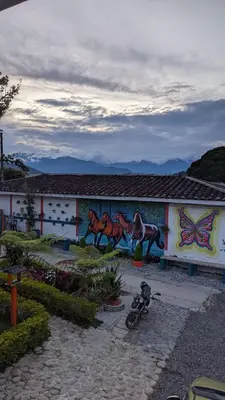 a building with a painting of horses on it at Hotel Dulce Campestre in Jardin