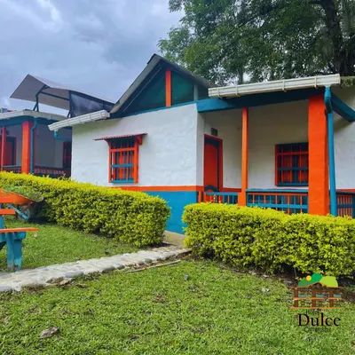 a colorful house with bushes in front of it at Hotel Dulce Campestre in Jardin