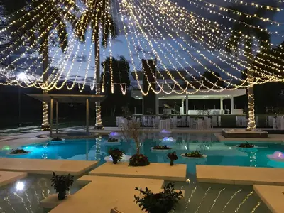 a wedding venue with lights and a swimming pool at Arena de Santa Fe by Bernalo Hotels in Santa Fe de Antioquia