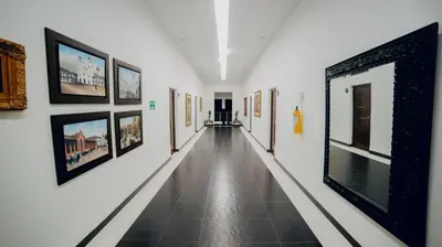 a hallway with pictures on the walls of a museum at Arena de Santa Fe by Bernalo Hotels in Santa Fe de Antioquia