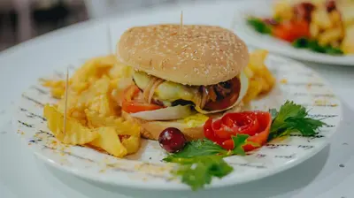 a plate of food with a sandwich and french fries at Arena de Santa Fe by Bernalo Hotels in Santa Fe de Antioquia