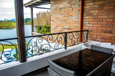 a balcony with a view of the water at Hotel La Magdalena in Guatapé