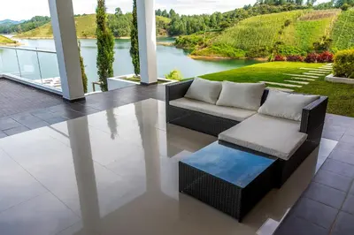 a living room with a couch and a view of a river at Hotel La Magdalena in Guatapé