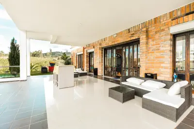 a living room with couches and a brick wall at Hotel La Magdalena in Guatapé