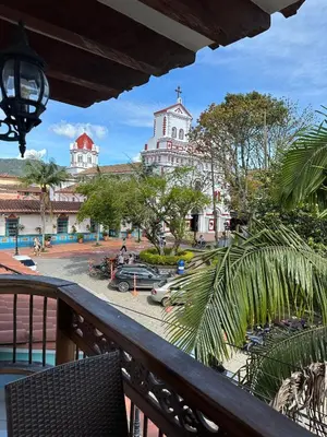 a balcony with a view of a street and a church at Hotel Bahia Guatape in Guatapé
