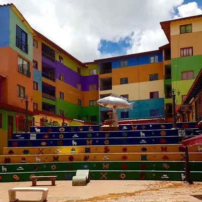 a colorful building with a fountain in front of it at Hotel Las Vegas in Guatapé