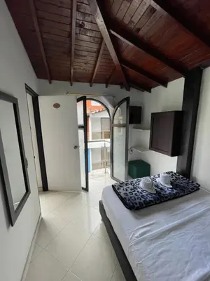 a bedroom with a bed and a tv in it at Hotel Las Vegas in Guatapé