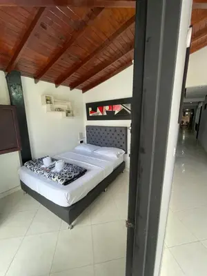 a bedroom with a large bed in a room at Hotel Las Vegas in Guatapé