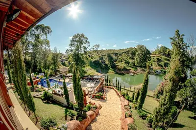 a view of a resort with a lake at Mansión by Bernalo Hotels in Guatapé