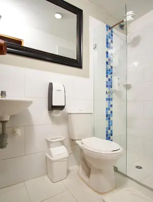 a bathroom with a toilet and a sink and a shower at Mansión by Bernalo Hotels in Guatapé