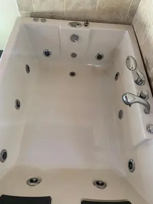 a white bath tub with a sink in a bathroom at Oak Tree house in Guatapé