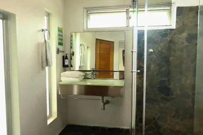 a bathroom with a sink and a mirror at Hotel Portobelo Guatape in Guatapé