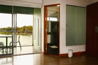 a room with a glass door with a balcony at Hotel Portobelo Guatape in Guatapé