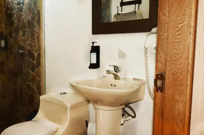 a bathroom with a sink and a toilet at Hotel Portobelo Guatape in Guatapé