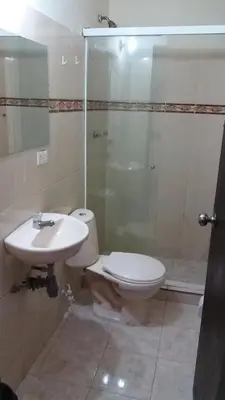 a bathroom with a toilet and a sink and a shower at hotel medellin calasanz in Medellín