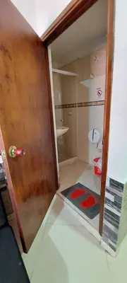 a small bathroom with a shower and a toilet at hotel medellin calasanz in Medellín