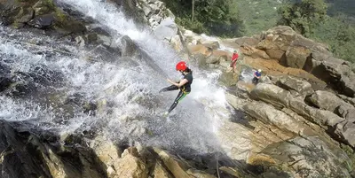 a man is riding a waterfall on a raft at Lake View Hostel in Guatapé