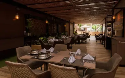 a dining room with tables and chairs and a unintention at Hotel Lomas 10 Medellin in Medellín