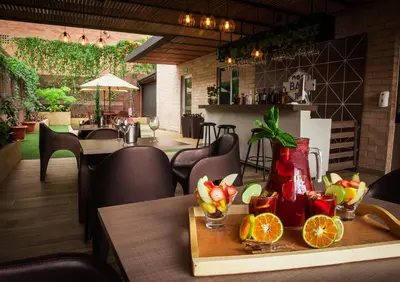 a restaurant with a table with fruit on it at Hotel Lomas 10 Medellin in Medellín