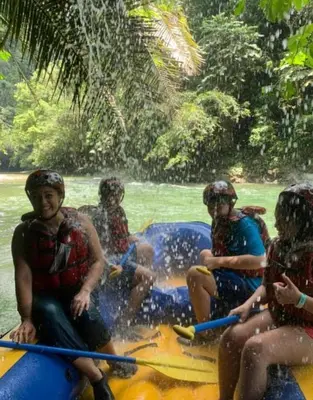 a group of people riding a raft on a river at Biohotel Rio Claro in Doradal
