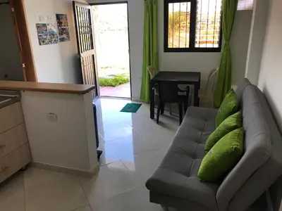 a living room with a couch and a table at Apartahotel El Horizonte in Guatapé