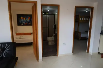 a bathroom with a toilet and a mirror at Apartahotel El Horizonte in Guatapé