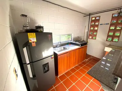 a small kitchen with a refrigerator and a sink at Apartasol San Jeronimo in San Jerónimo