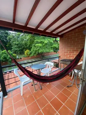 a hammock on the balcony of a house at Apartasol San Jeronimo in San Jerónimo