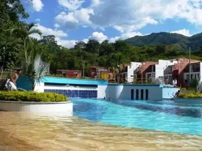 a large swimming pool with blue water and buildings at Apartasol San Jeronimo in San Jerónimo