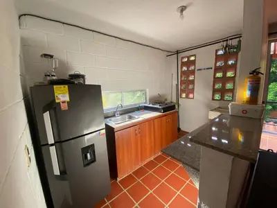 a kitchen with a refrigerator and a sink at Apartasol San Jeronimo in San Jerónimo
