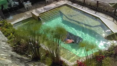 an overhead view of a pool with a person in the water at Hotel Termales Tierra Viva in Manizales